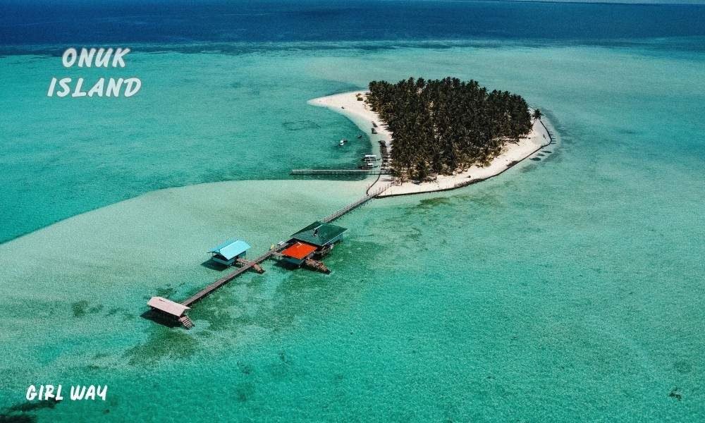 Aerial view of Onuk Island with wooden boardwalks over turquoise water, connected to my journey on How to Get to Balabac, Palawan.